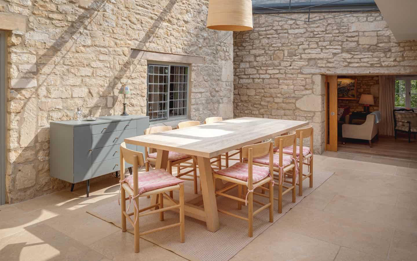 The Mount light-filled dining room with stone walls, oak table and chairs in converted courtyard, Stroud